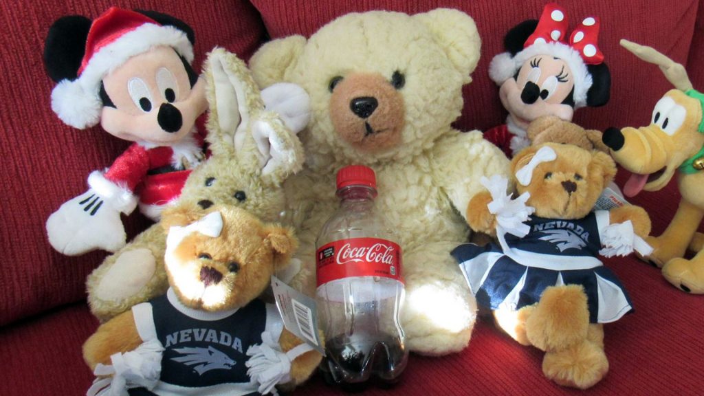 Ambyr Noelle with other plush animals including UNR Cheerleader bears