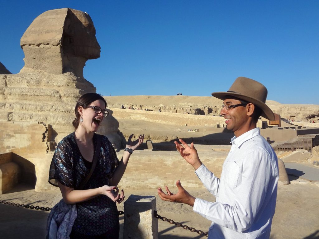 Ahmed mirrors hand gestures with another person near The Sphinx in Egypt