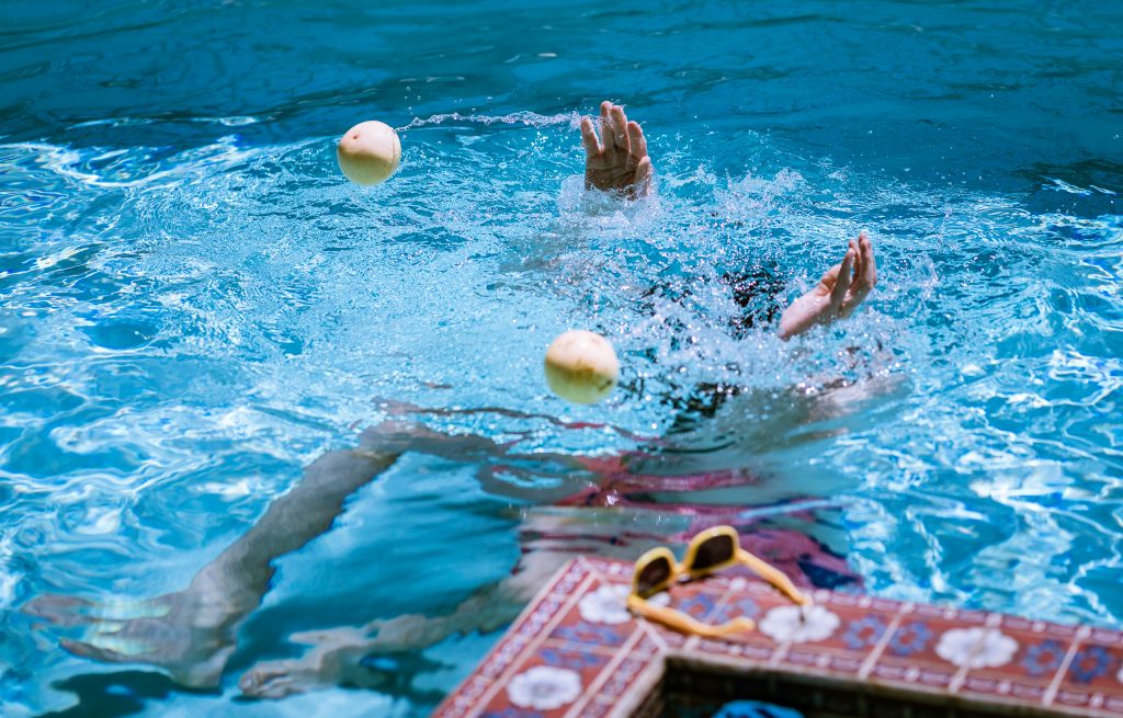 Benjamin Geyer recording sounds in a pool with a hydrophone