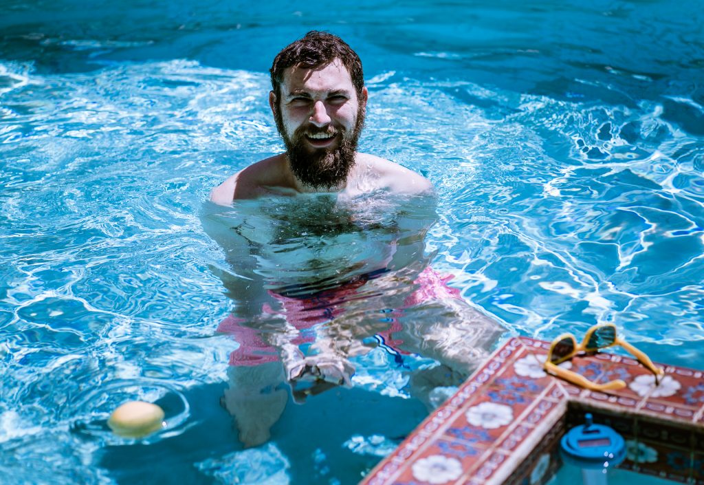 Benjamin Geyer recording sounds in a pool with a hydrophone