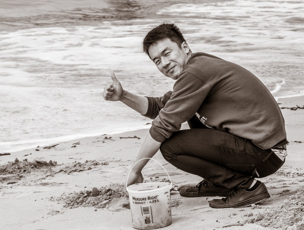 Kewei working in the sand at the Seal Beach Pier