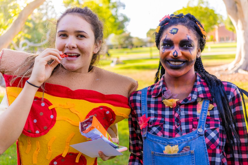 Halloween costume  contest. Kaelie Osorio wearing a Pepperoni Pizza costume and eating a bag of Flaming Hot Cheetos