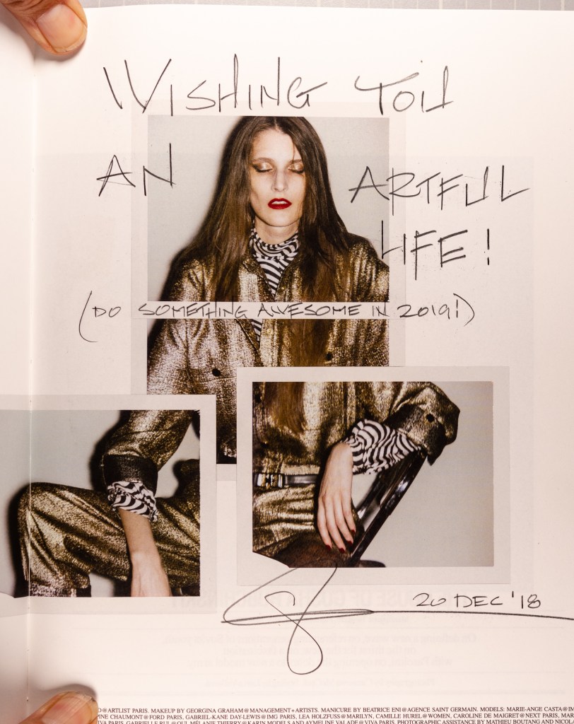 a page from the Fall/Winter 2016 issue of Self Service magazine with hand lettering over the polaroids on the page. The lettering reads, "Wishing you an artful life! (do something awesome in 2019!) - Glenn, 20 Dec '18"