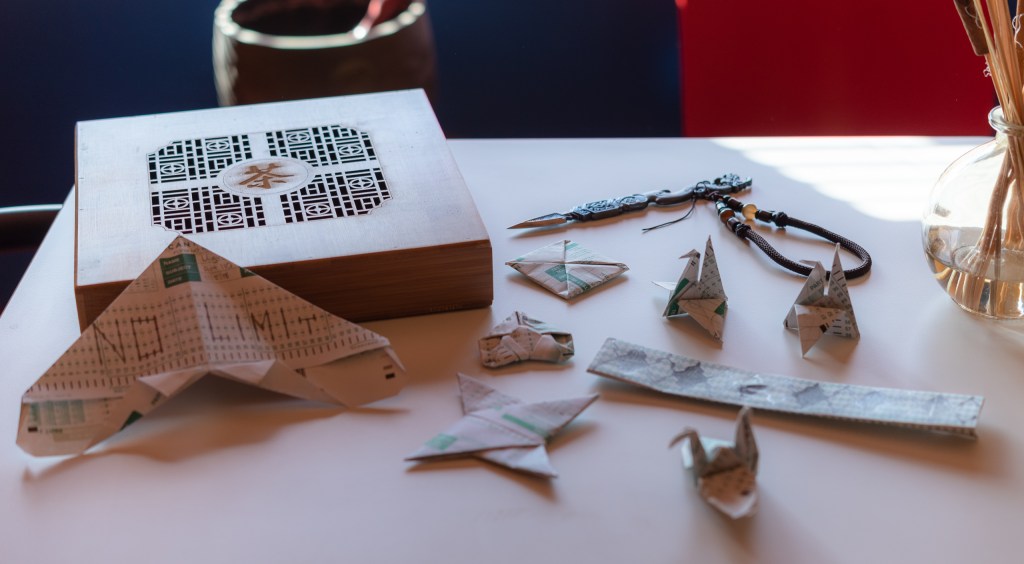 photo of scantron 882-e forms folded into various origami shapes including several origami cranes and other shapes