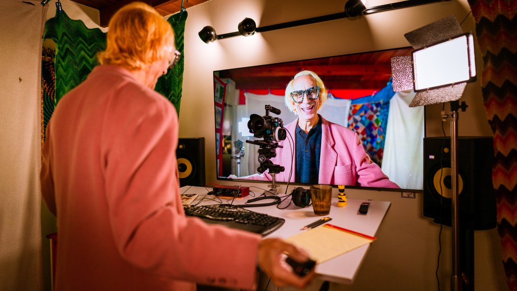 Glenn Zucman facing his own image on a video screen presenting a Zoom meeting.