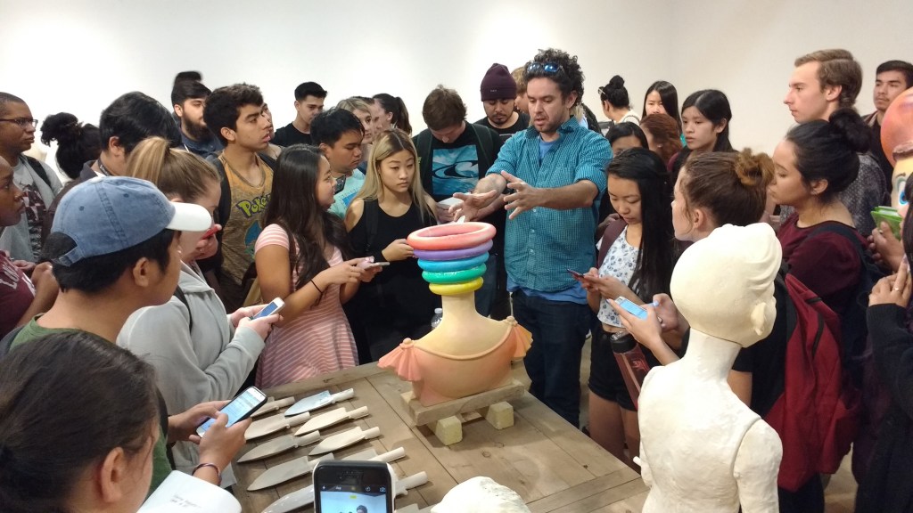 Samuel Jernigan discussing work with a crowd of students