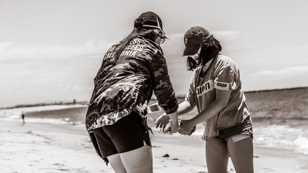 Working with a plaster casting at the shoreline at the Seal Beach Pier in Southern California