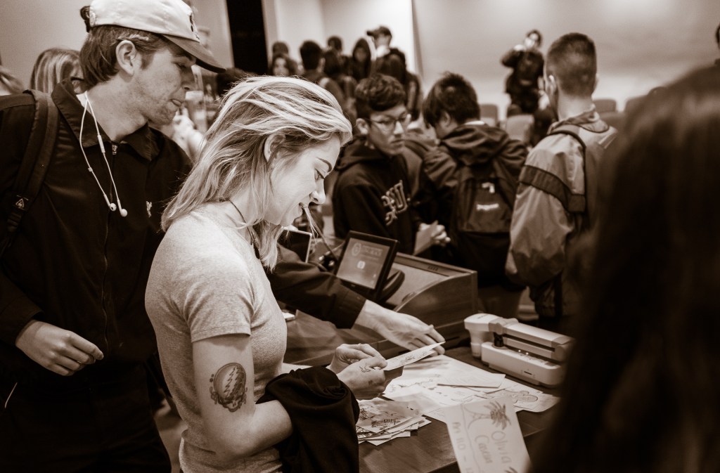 Artist Lizzie Green looking at student ID Card Drawings