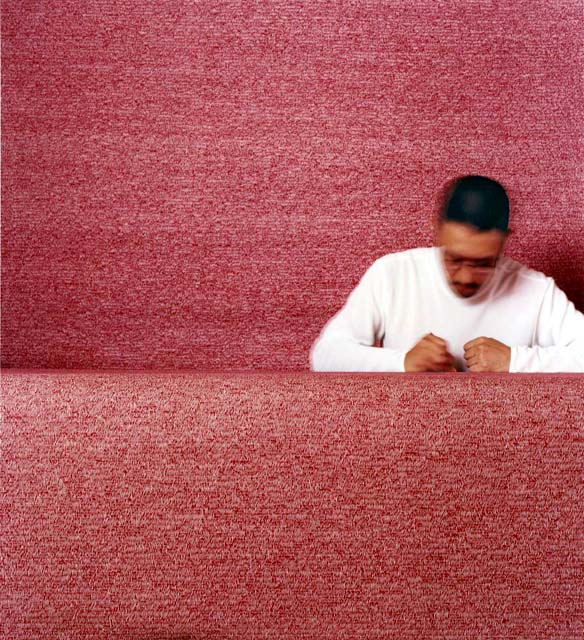 photo of Makoto Sasaki making many thousands of tiny red marks on huge sheets of paper