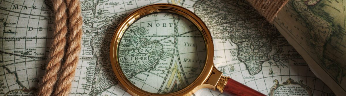 photo of a map with a magnifying glass on top of it