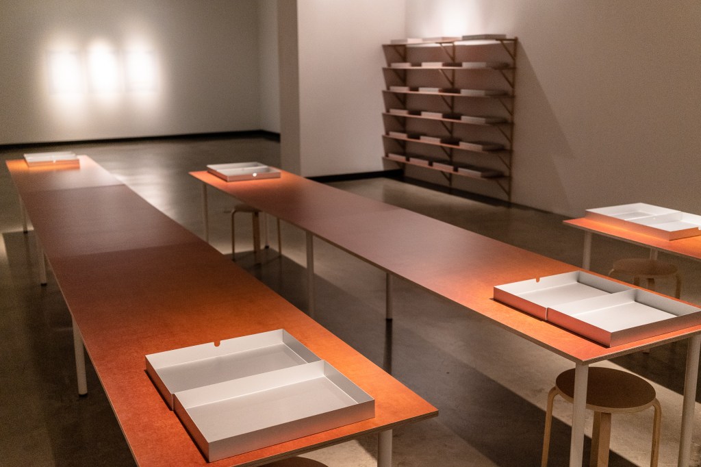 room view of 3 tables and shelves of aluminum boxes