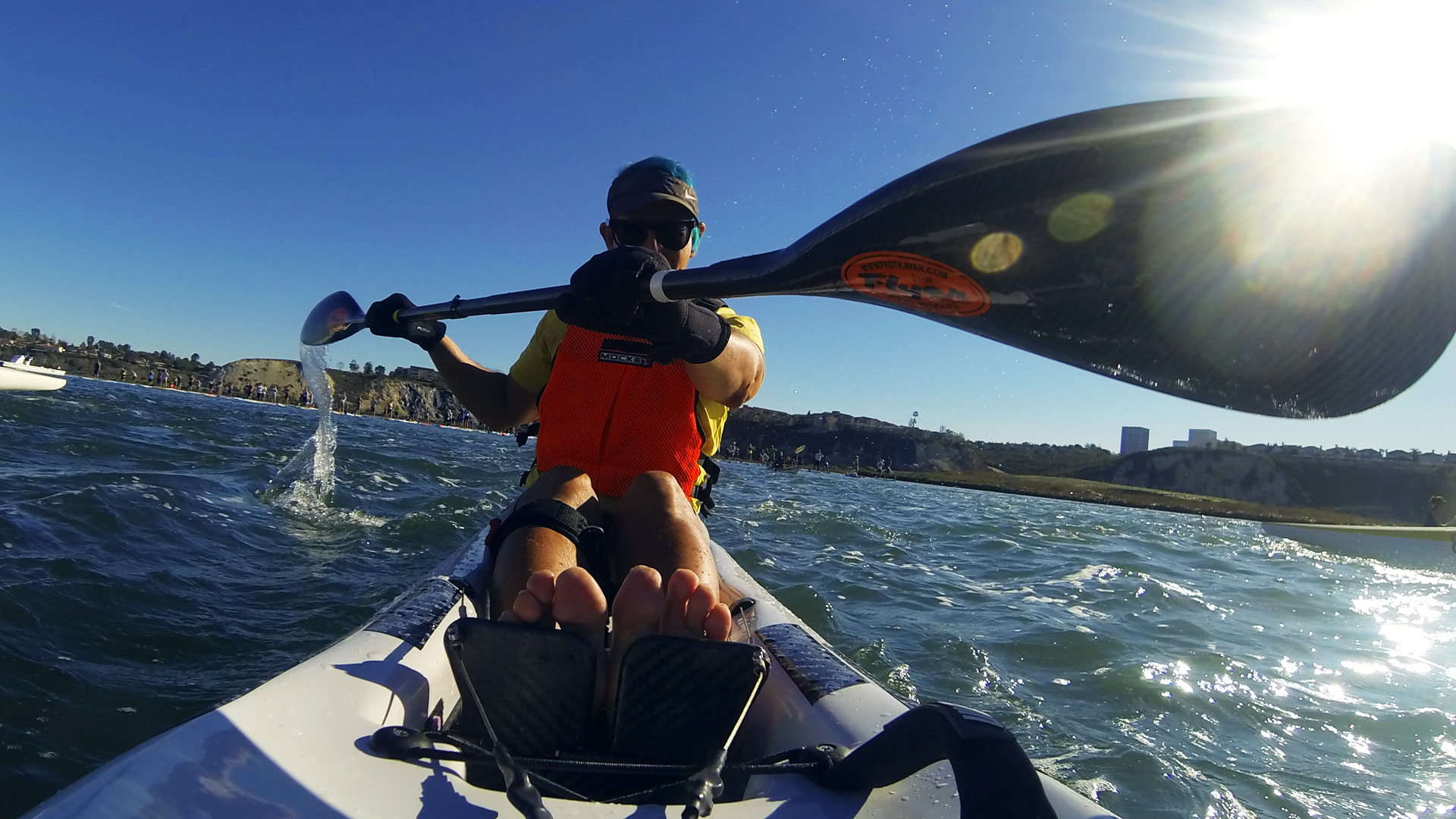 Glenn Zucman paddling a surf ski on the Newport Coast